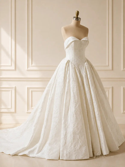 Strapless dusty blue jacquard wedding dress with a sweetheart neckline and a full, pleated ball gown skirt.