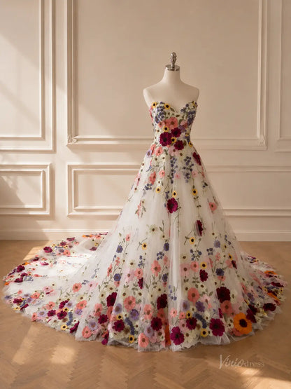 Strapless A-line wedding dress in white tulle featuring vibrant, multi-colored 3D floral embroidery and a long train.