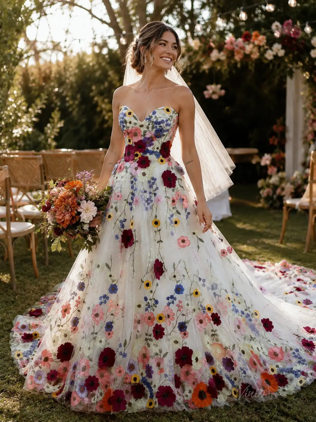 Strapless A-line wedding dress featuring colorful floral embroidery on white tulle with a sweetheart neckline and veil.