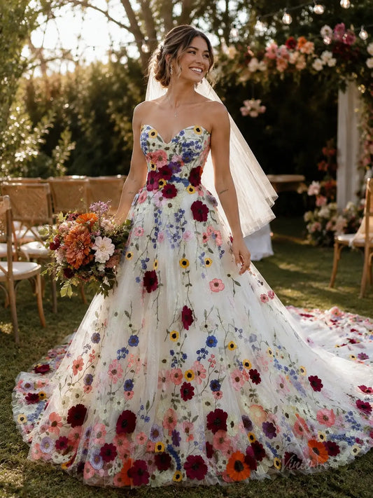 Strapless A-line wedding dress featuring colorful floral embroidery on white tulle with a sweetheart neckline and veil.