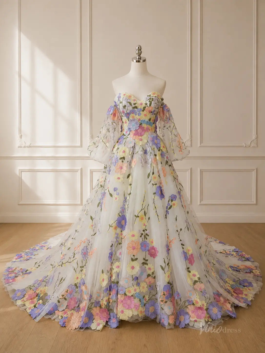Off-the-shoulder ball gown with colorful 3D floral embroidery, sheer puff sleeves, and a long tulle train.