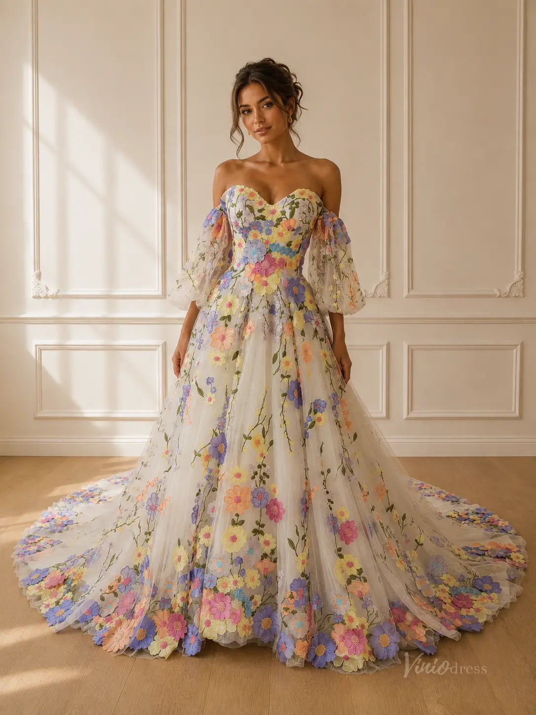Off-the-shoulder ball gown with colorful 3D floral embroidery, sweetheart neckline, and voluminous tulle skirt.