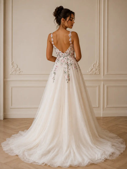 A-line wedding dress with a V-back, floral embroidery, spaghetti straps, and a flowing tulle skirt in ivory.