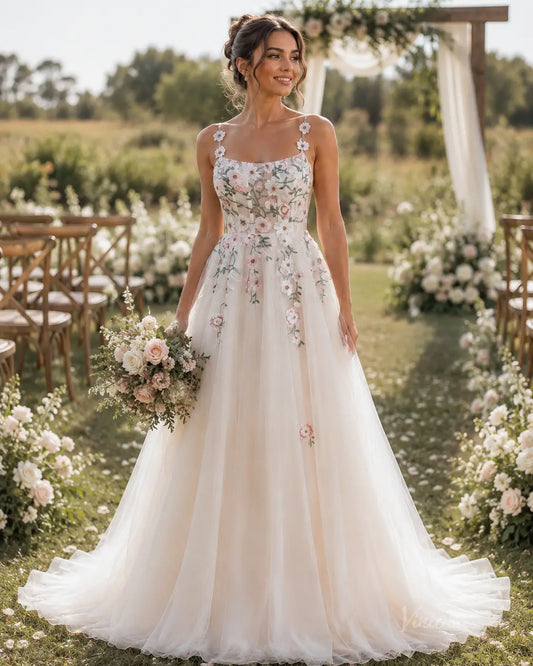 A-line wedding dress FW298 featuring a sheer bodice with delicate floral embroidery, spaghetti straps, and a flowing tulle skirt.