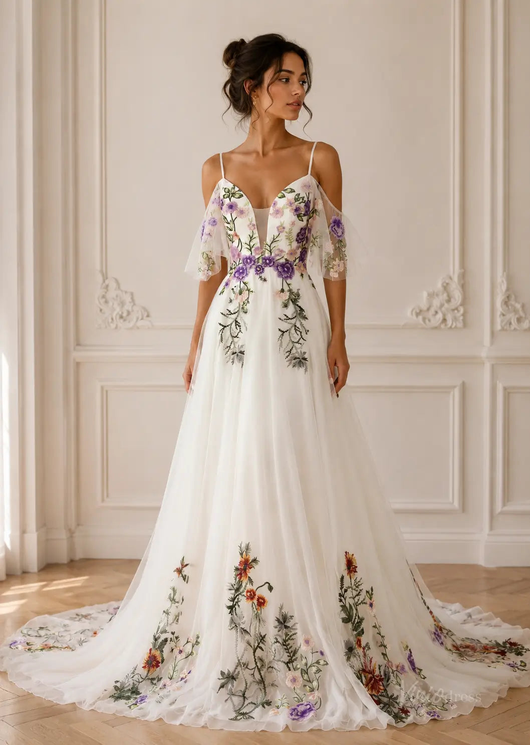 White pleated chiffon wedding dress with cold-shoulder sleeves and colorful floral embroidery throughout the skirt.