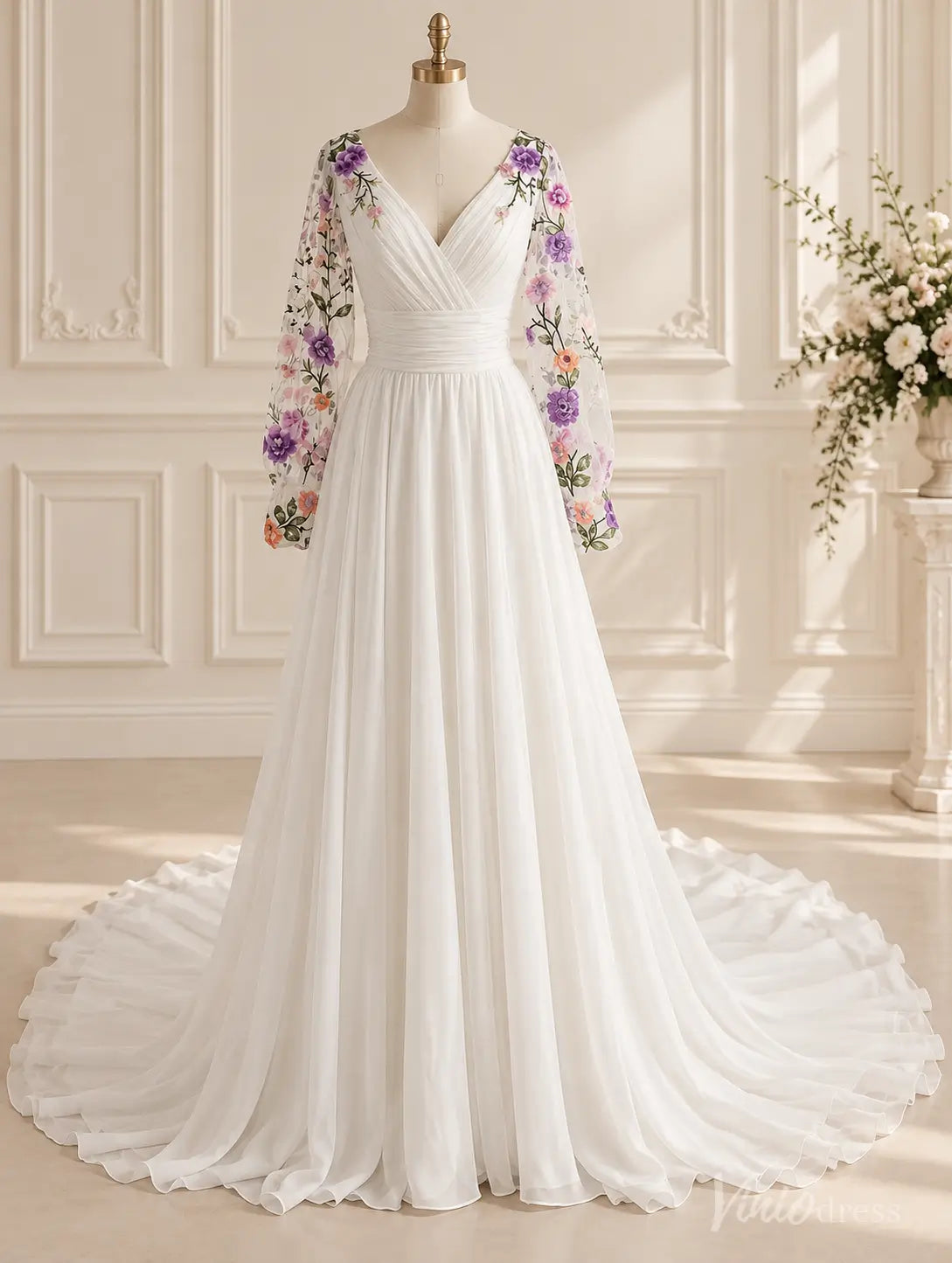 Ivory chiffon A-line wedding dress with floral embroidered long bishop sleeves, V-neck, ruched waistband, and sweeping train.