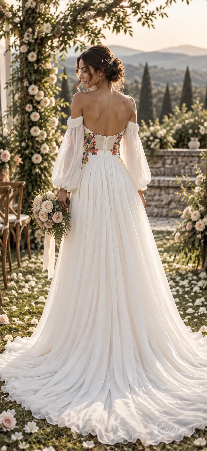White chiffon A-line wedding dress with off-the-shoulder bishop sleeves, floral waist embroidery, and a sweeping train.