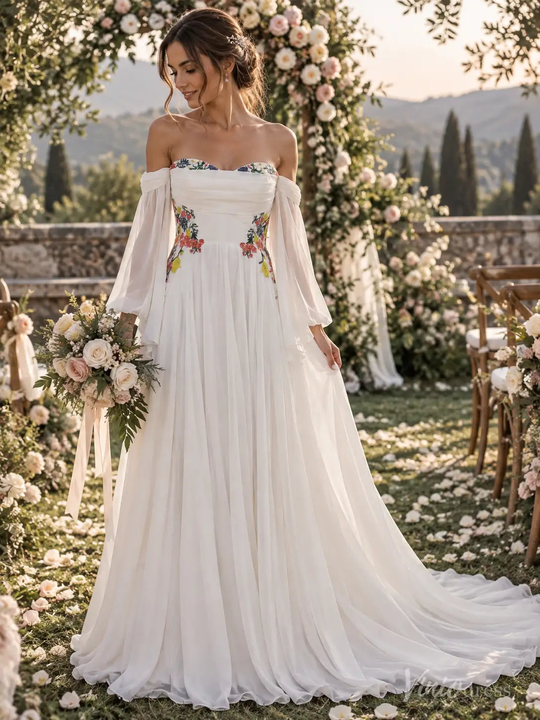 White chiffon A-line wedding dress with off-the-shoulder bishop sleeves and colorful floral embroidery at the bodice.