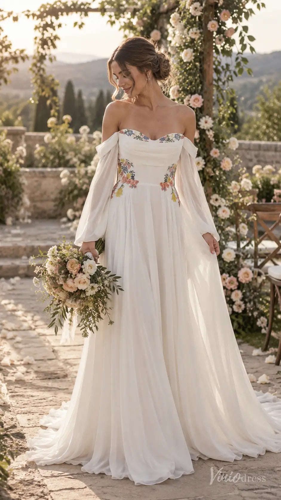 Floral chiffon A-line wedding dress with off-the-shoulder bishop sleeves and colorful botanical embroidery.