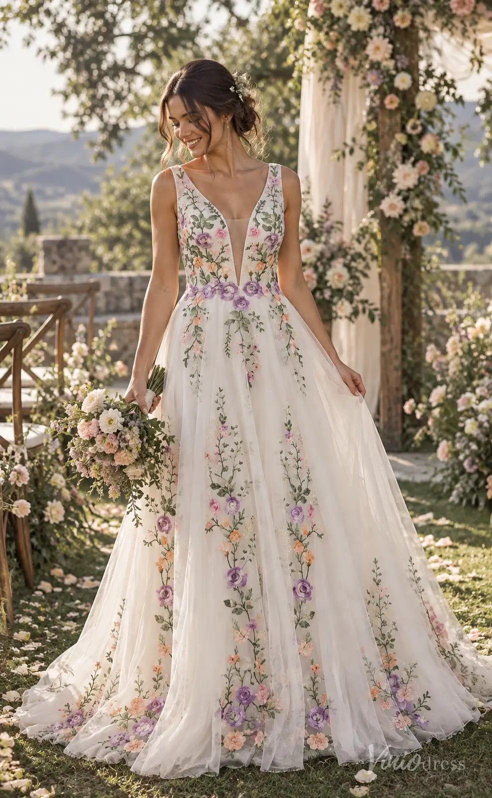 A-line wedding dress with colorful floral embroidery, plunging V-neck, and layered tulle skirt in a garden setting.