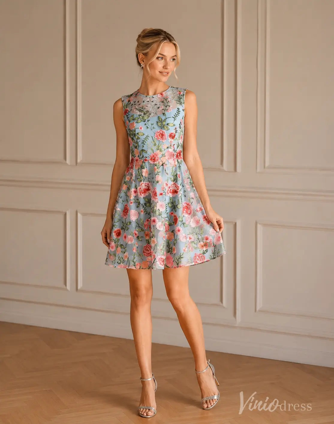 Light blue sleeveless A-line mini dress S26148 with pink floral embroidery and silver heels.