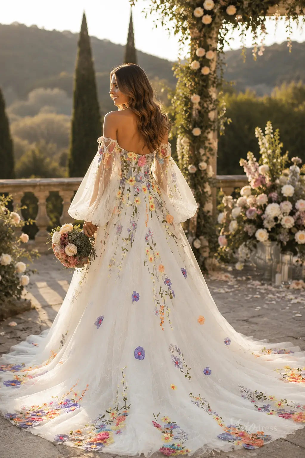 Off-the-shoulder A-line wedding dress with sheer puff sleeves and colorful floral embroidery on white tulle fabric.
