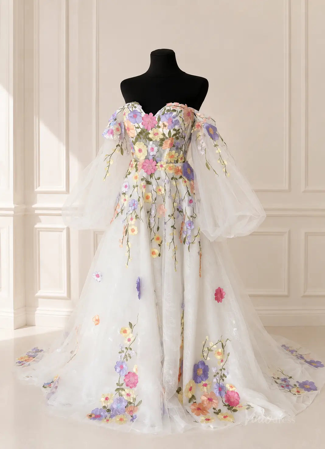 Off-the-shoulder white tulle wedding dress featuring colorful 3D floral embroidery and voluminous sheer puff sleeves.