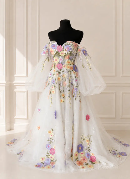 Off-the-shoulder white tulle wedding dress featuring colorful 3D floral embroidery and voluminous sheer puff sleeves.