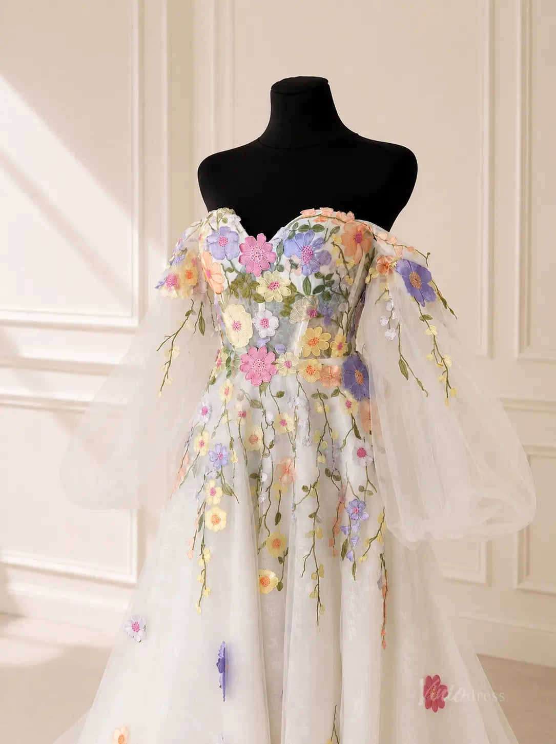 Off-the-shoulder tulle gown featuring colorful 3D floral embroidery, puff sleeves, and a sweetheart neckline.