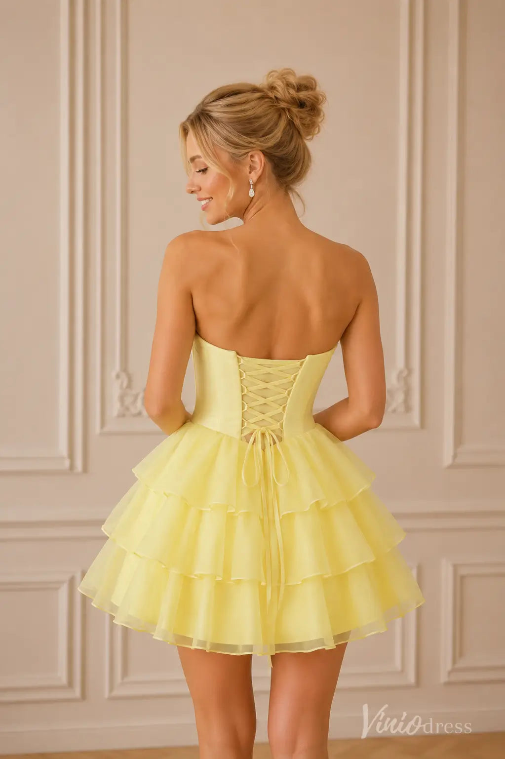 Yellow strapless short dress with a lace-up corset back and tiered ruffle skirt.
