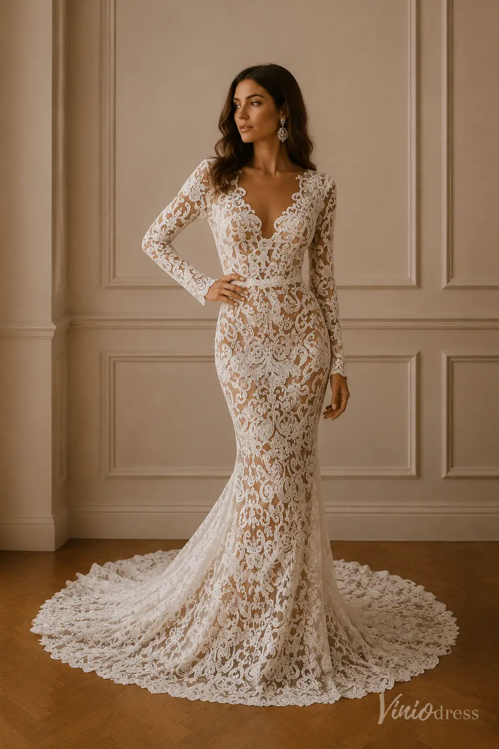 Long-sleeve mermaid wedding dress in white lace with a deep V-neckline and a sweeping train.