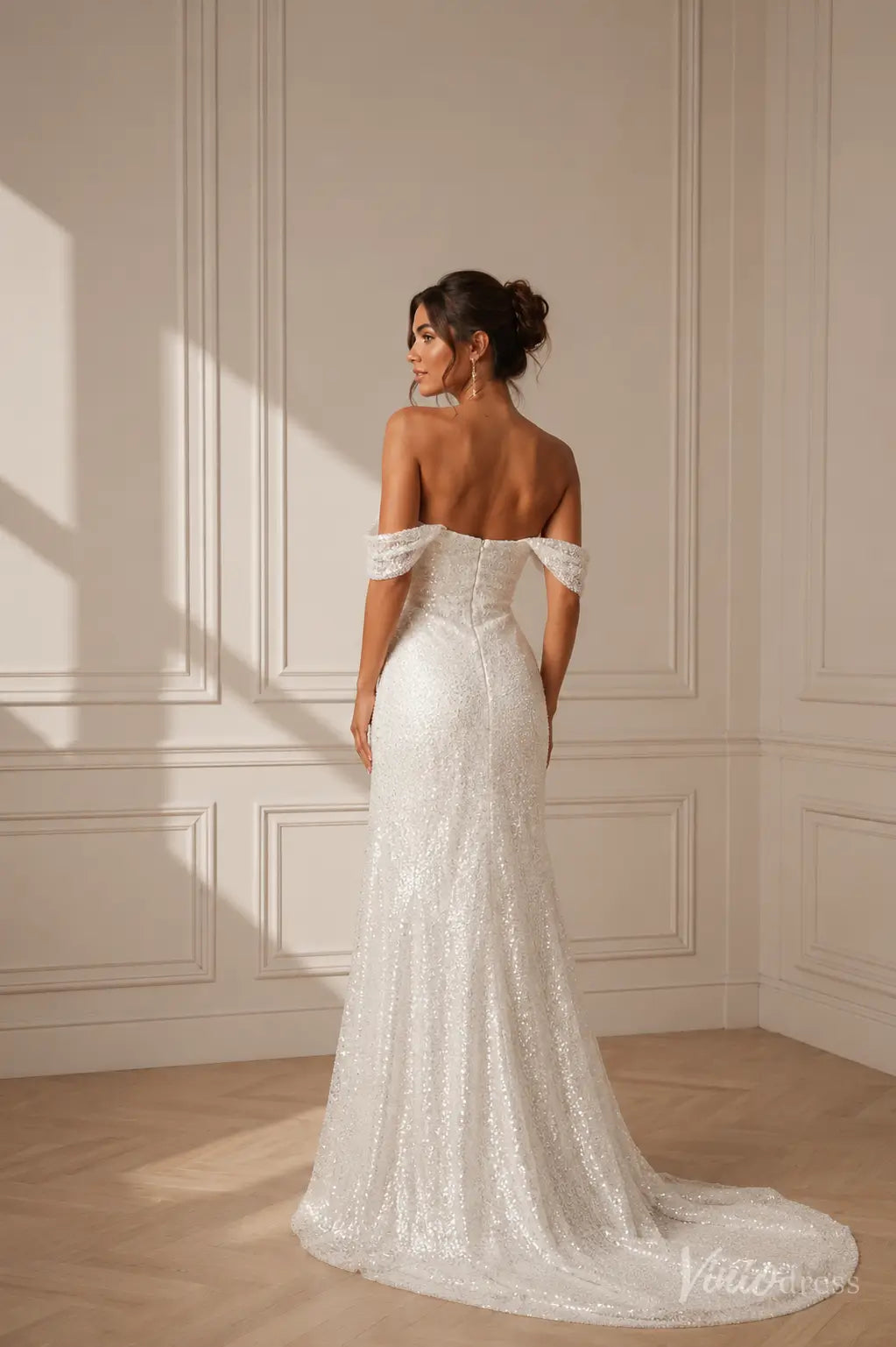 White sequin off-the-shoulder wedding dress with a fitted bodice and elegant floor-length train.