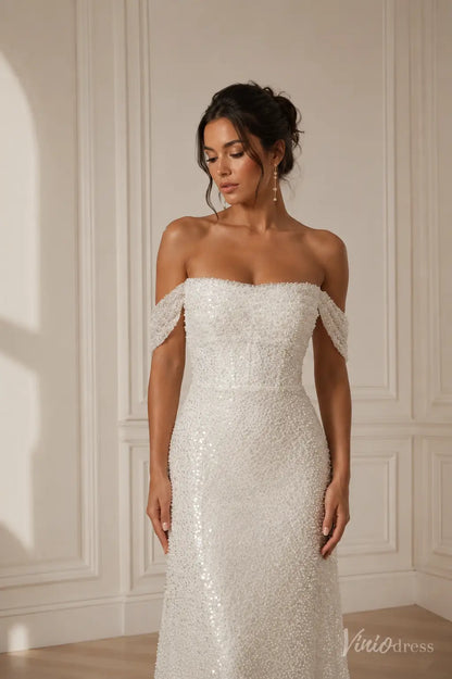 Off-the-shoulder white wedding dress featuring intricate pearl and sequin embellishments on a fitted bodice.