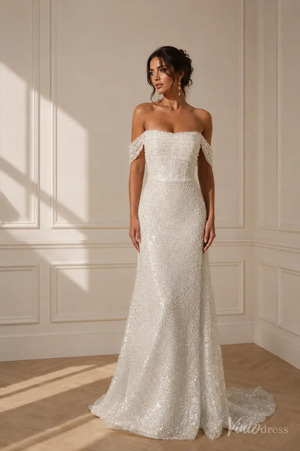 Off-the-shoulder white sequin wedding dress with a fitted bodice and a subtle train in a classic bridal style.