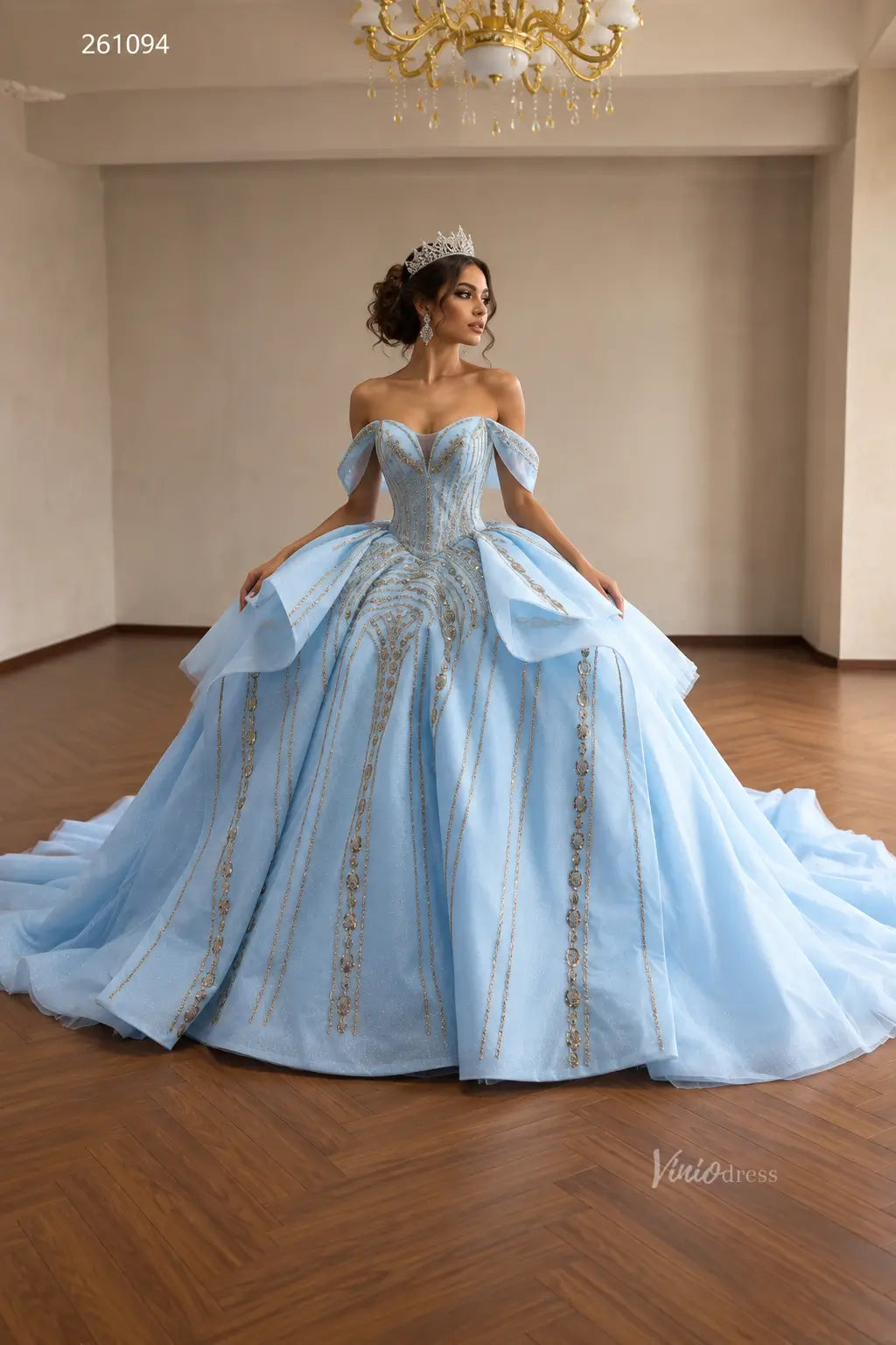 Light blue quinceañera ball gown with gold beaded vertical patterns, off-shoulder sweetheart neckline, and sculptural peplum.