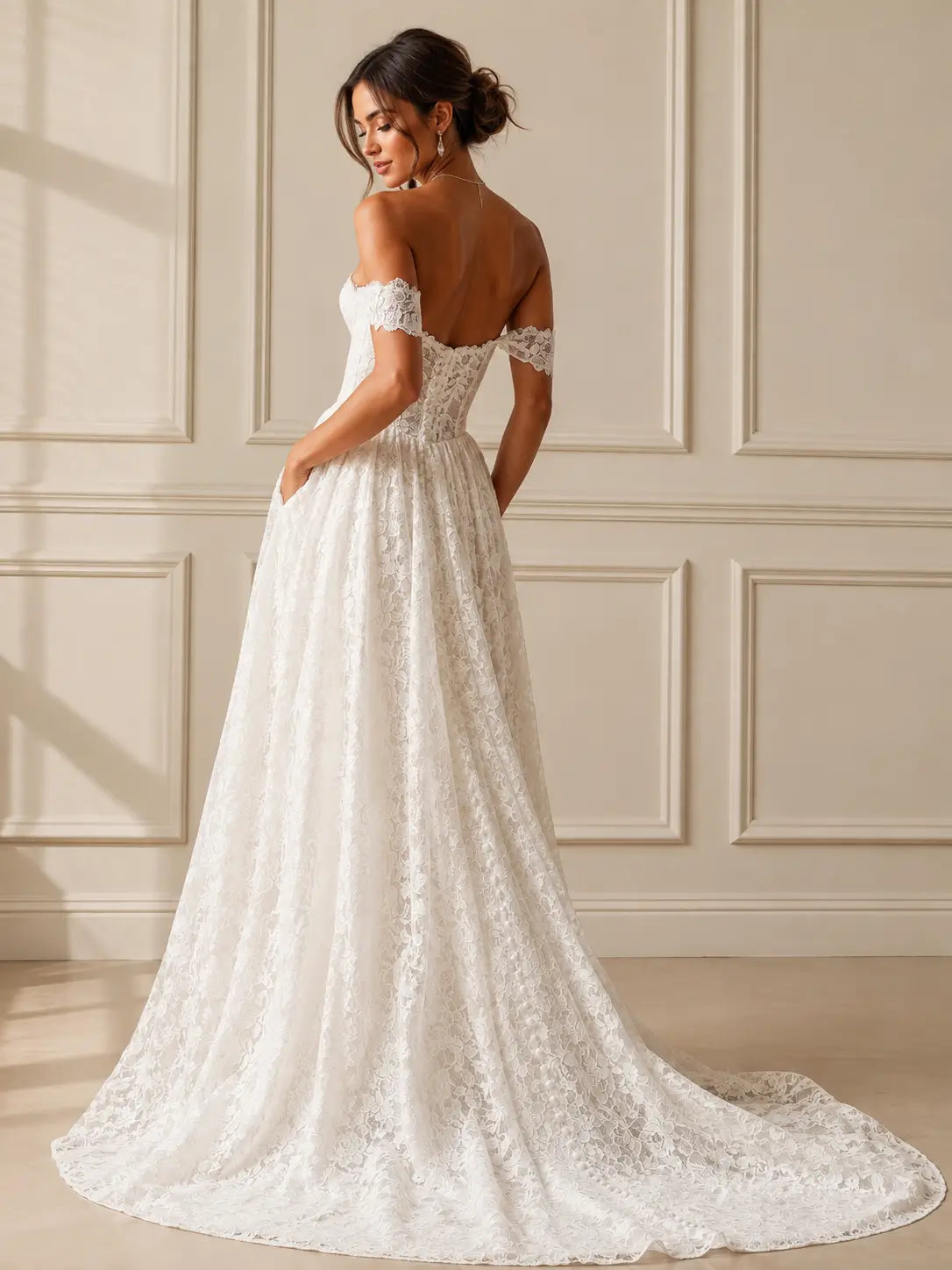 White lace A-line wedding dress with off-the-shoulder sleeves, a corset bodice, and pockets, shown from the back.