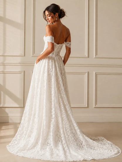 White lace A-line wedding dress with off-the-shoulder sleeves, a corset bodice, and pockets, shown from the back.