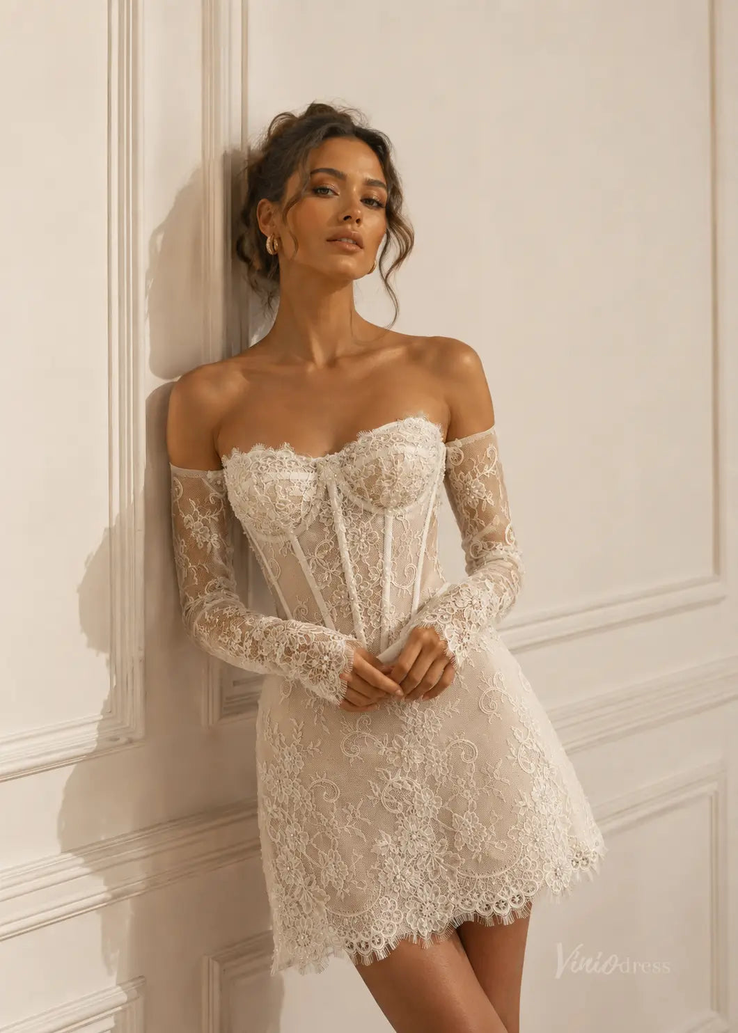 White lace mini wedding dress with a corset bodice, off-the-shoulder long sleeves, and intricate floral embroidery.