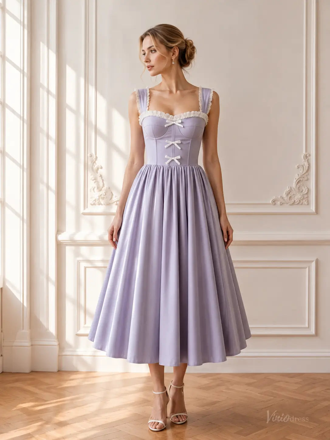 Lavender tea-length prom dress with a corset bodice, sweetheart neckline, white ruffle trim, and delicate bow details.