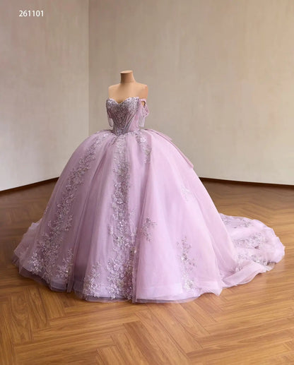 Lilac off-shoulder quinceañera ball gown with a crystal corset, 3D floral appliqués, and a full embroidered tulle skirt.