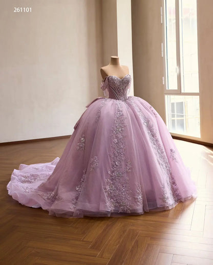 Lilac off-shoulder quinceañera ball gown with crystal corset, 3D floral appliqués, and a full tulle skirt with train.