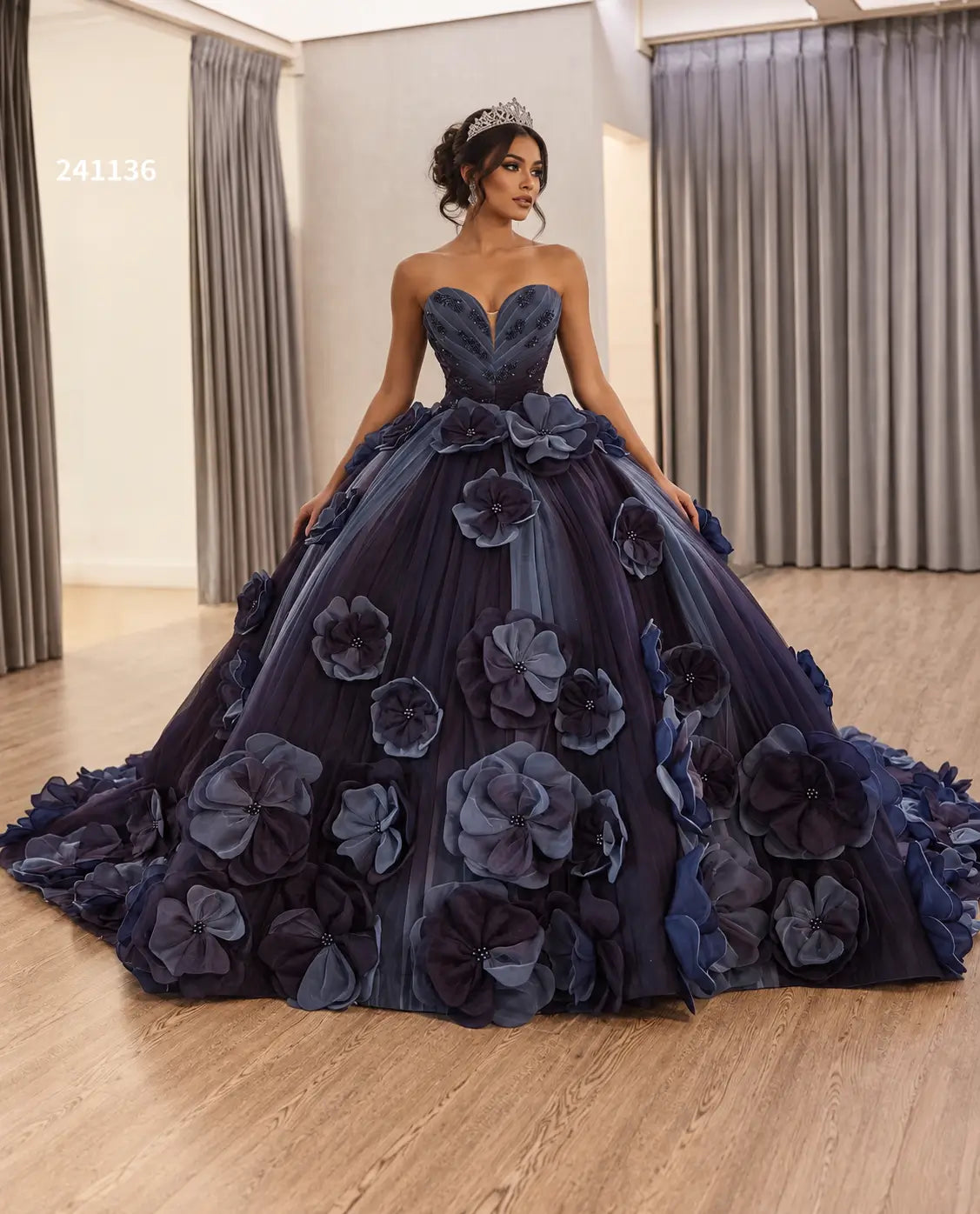 Luxury navy blue ball gown with a sweetheart neckline and 3D floral petal appliqués on a full tulle skirt with a train.