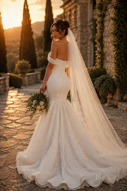 Off-the-shoulder white lace mermaid wedding dress with a long veil and train, set against a sunset garden backdrop.