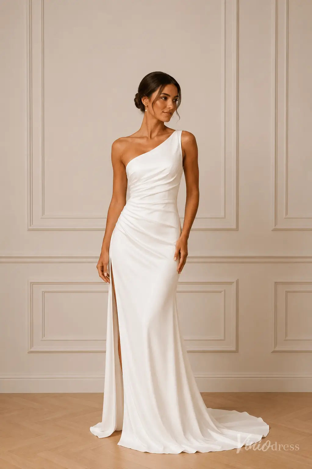 White one-shoulder satin bridal gown featuring a ruched bodice and a high side slit with a floor-length train.