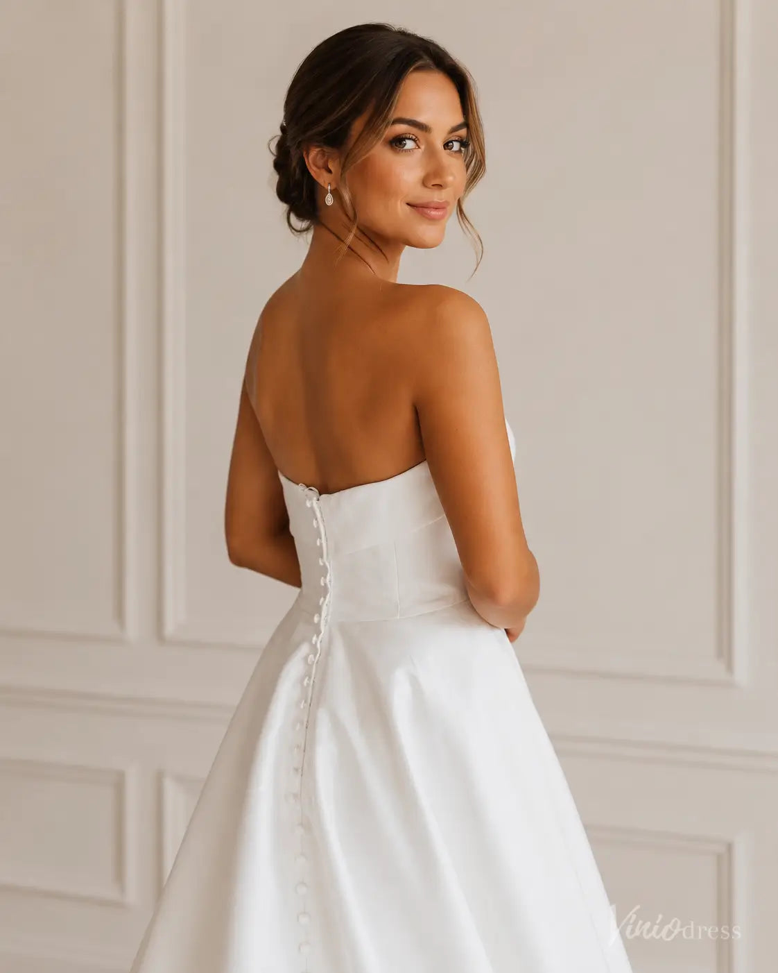Strapless white Mikado wedding dress with a button-down back and elegant A-line silhouette.