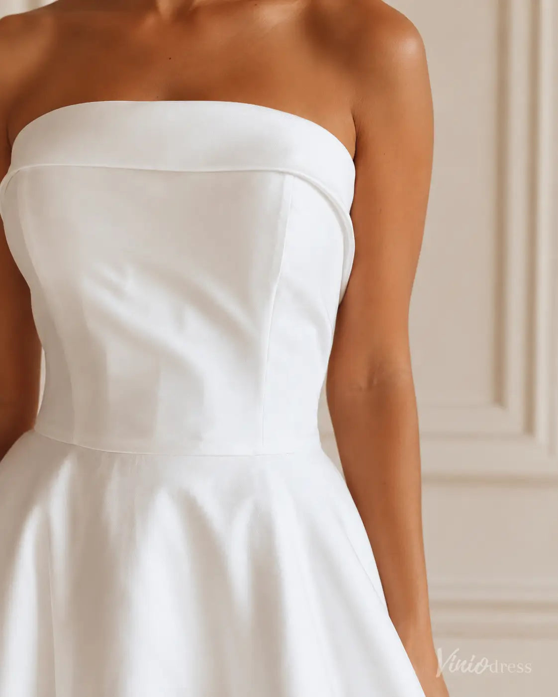 Strapless white Mikado wedding dress with a fitted bodice and flared skirt, showcasing a clean, elegant silhouette.