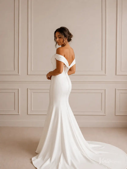 Minimalist white crepe mermaid wedding dress with off-shoulder folded neckline and button-down train.