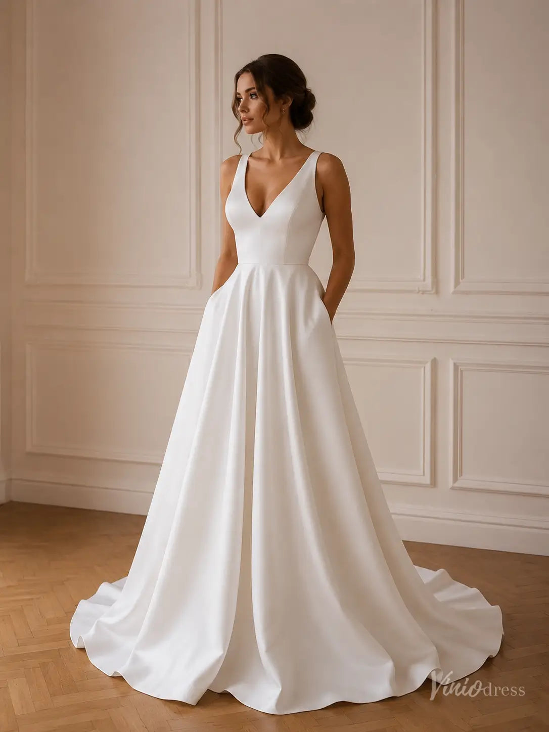 Minimalist white satin A-line wedding dress with a V-neck, sleeveless bodice, and convenient side pockets.