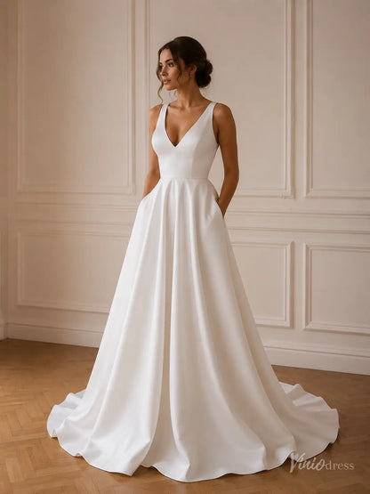 Minimalist white satin A-line wedding dress with a V-neck, sleeveless bodice, and convenient side pockets.