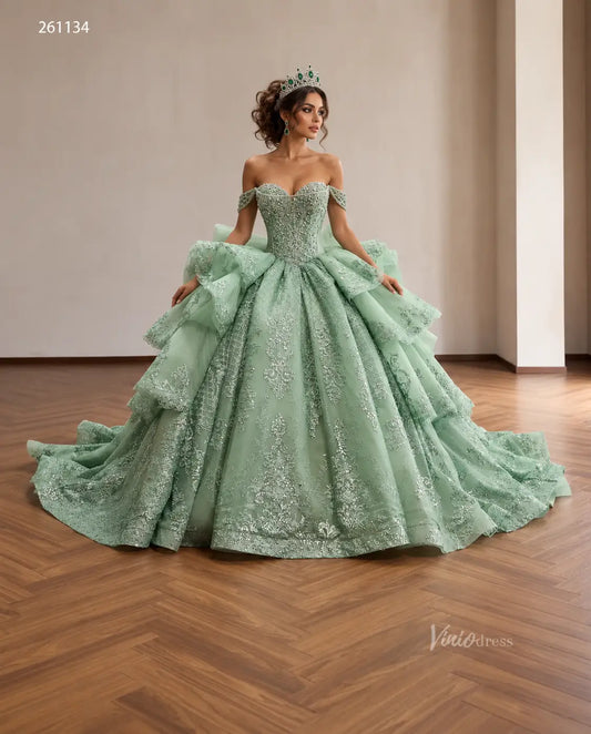 Mint green off-shoulder quinceañera dress with crystal corset, layered lace ruffles, and oversized back bow.