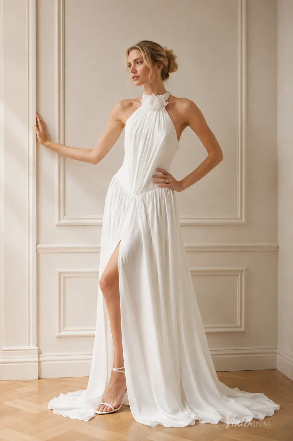 White chiffon A-line beach wedding dress featuring a halter neckline with floral detail and a high leg slit.