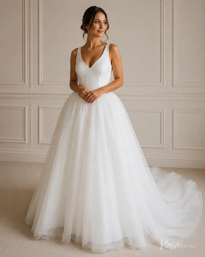 White A-line wedding dress with a V-neck bodice and a voluminous layered tulle skirt with a long train.