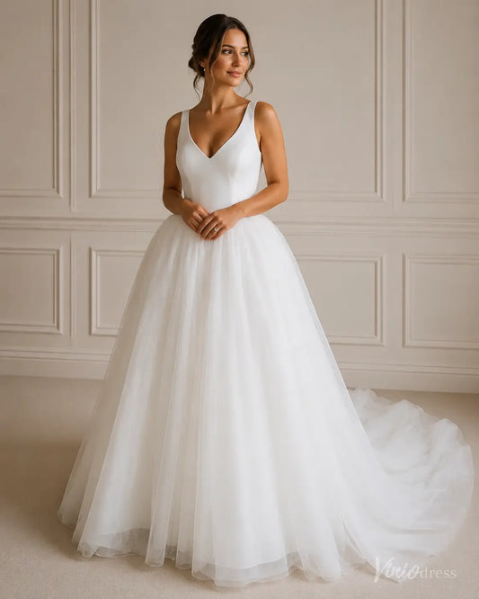 White A-line wedding dress with a V-neck bodice and a voluminous layered tulle skirt with a long train.