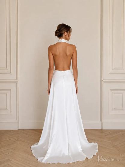 Minimalist white satin wedding dress with a halter neckline, open back, and flowing A-line skirt.