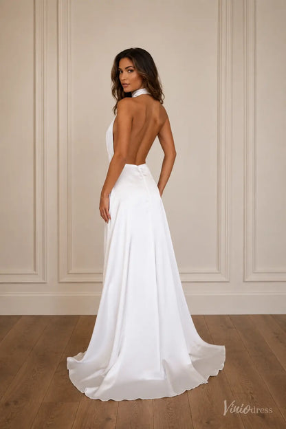 Minimalist white satin wedding dress with a halter neckline, plunging open back, and flowing A-line skirt.