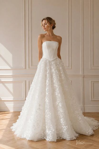 White strapless wedding dress with a structured corset bodice and a voluminous A-line skirt featuring 3D floral appliqués.