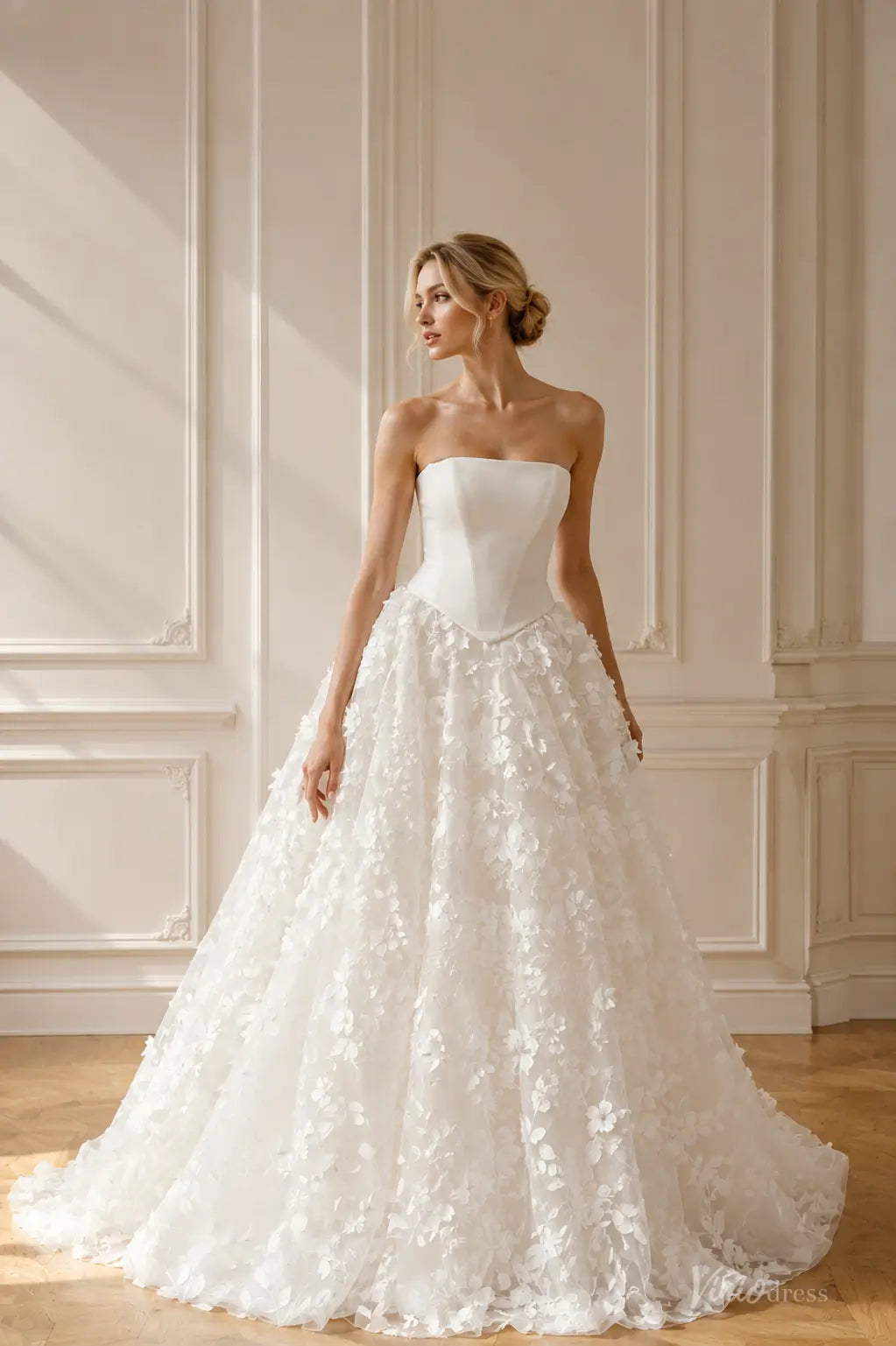 White strapless ballgown wedding dress with a structured corset bodice and a full skirt featuring 3D floral appliqués.