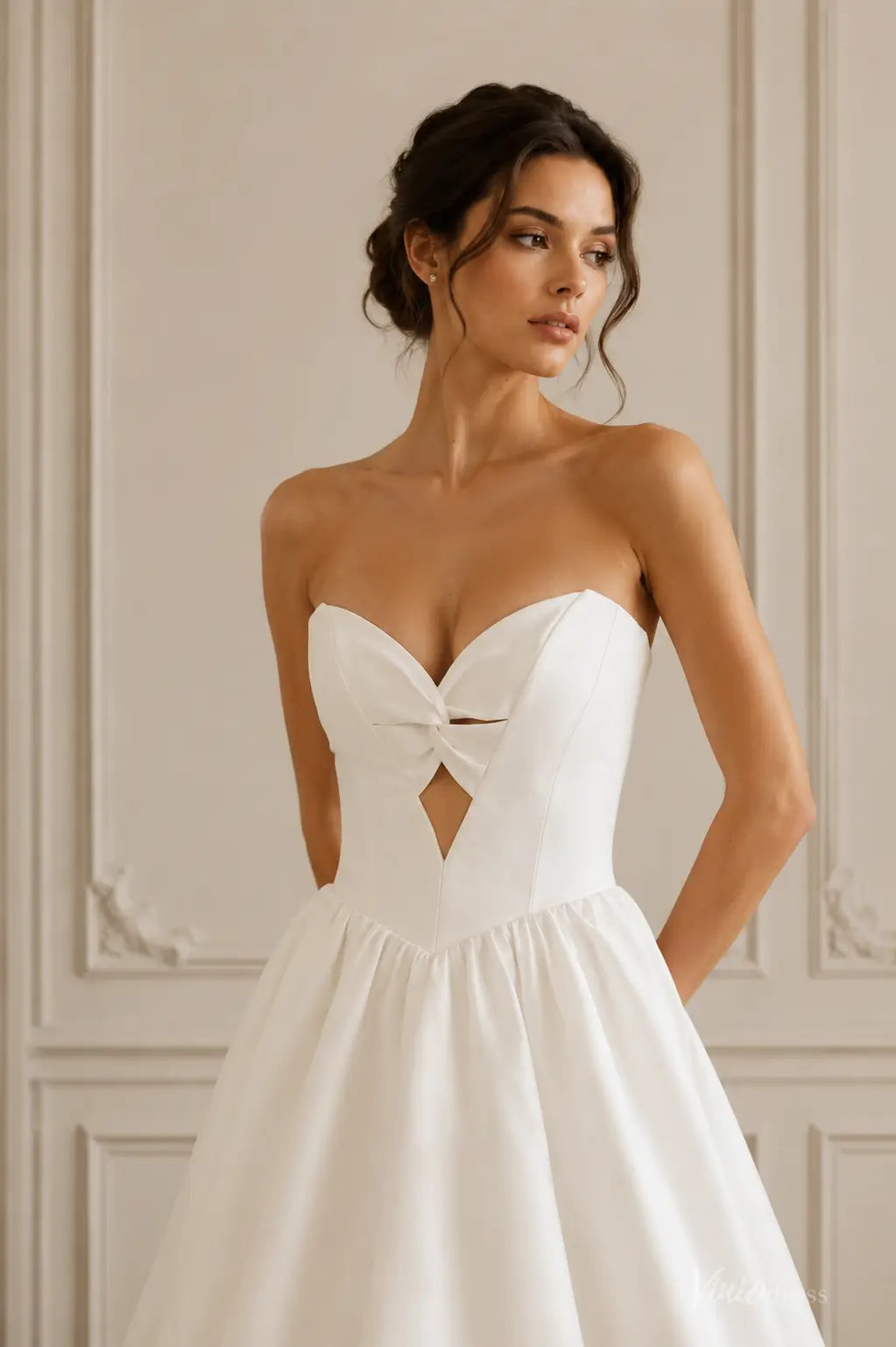 Ivory satin A-line wedding dress with a strapless sweetheart neckline, twist-front bodice, and diamond-shaped cutout.