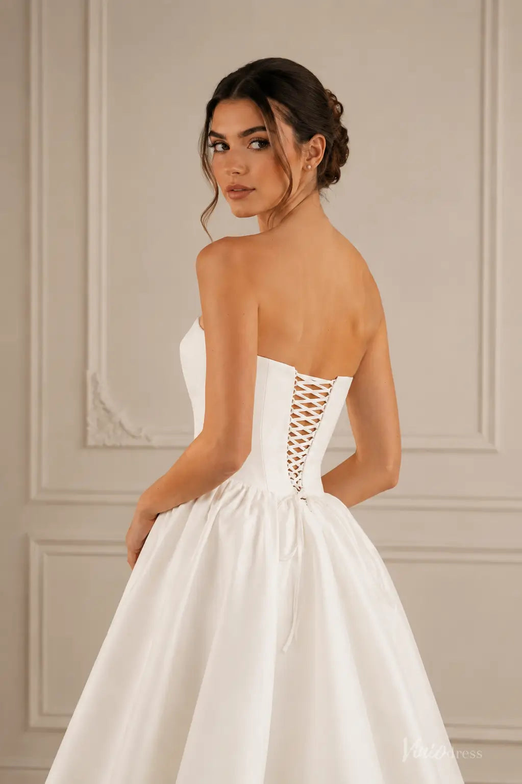 Ivory satin A-line wedding dress featuring a strapless corset bodice with a lace-up back and a full skirt.