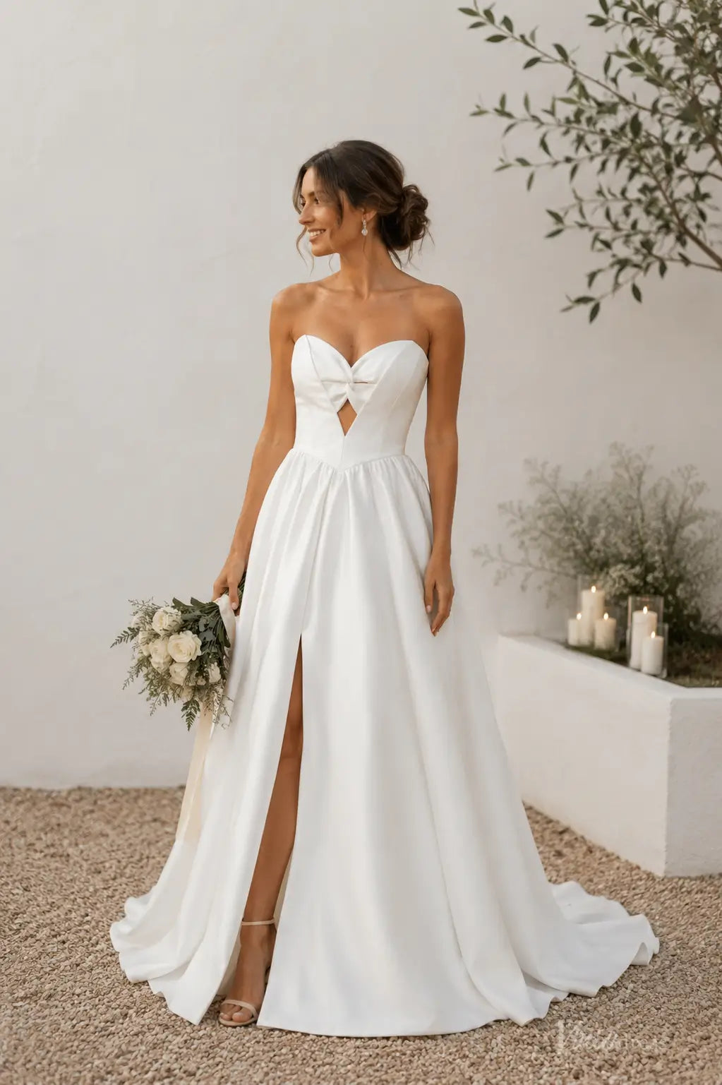 Ivory satin A-line wedding dress with a strapless sweetheart bodice, twist-front detail, cutout, and high leg slit.